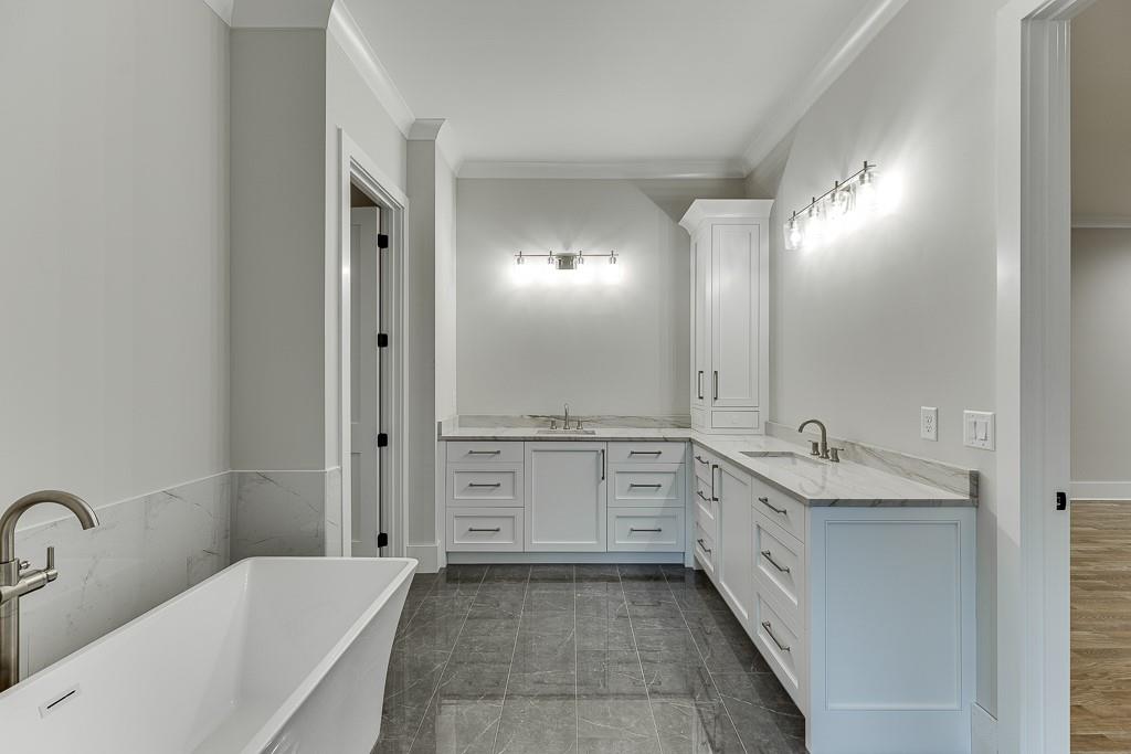 7620 Breeze Bay Road Cumming, GA 30041 - Photo 24 of 53 a bathroom with a tub sink and mirror