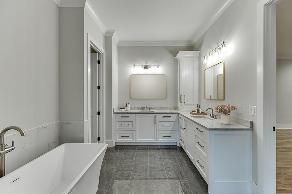 7620 Breeze Bay Road Cumming, GA 30041 - Photo 25 of 53 a bathroom with a double vanity sink mirror and bathtub