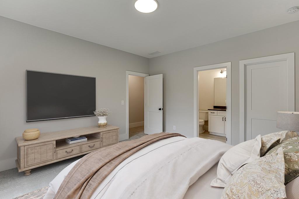 7620 Breeze Bay Road Cumming, GA 30041 - Photo 33 of 53 a bedroom with a bed and a flat screen tv