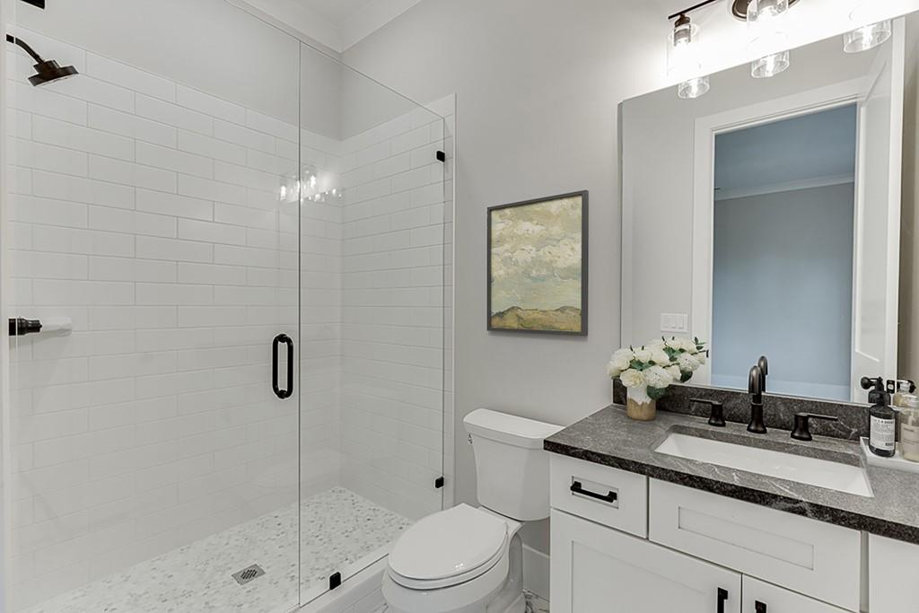 7620 Breeze Bay Road Cumming, GA 30041 - Photo 35 of 53 a bathroom with a sink a toilet and shower