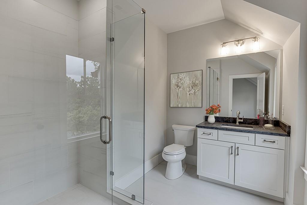 7620 Breeze Bay Road Cumming, GA 30041 - Photo 37 of 53 a bathroom with a toilet a sink and mirror