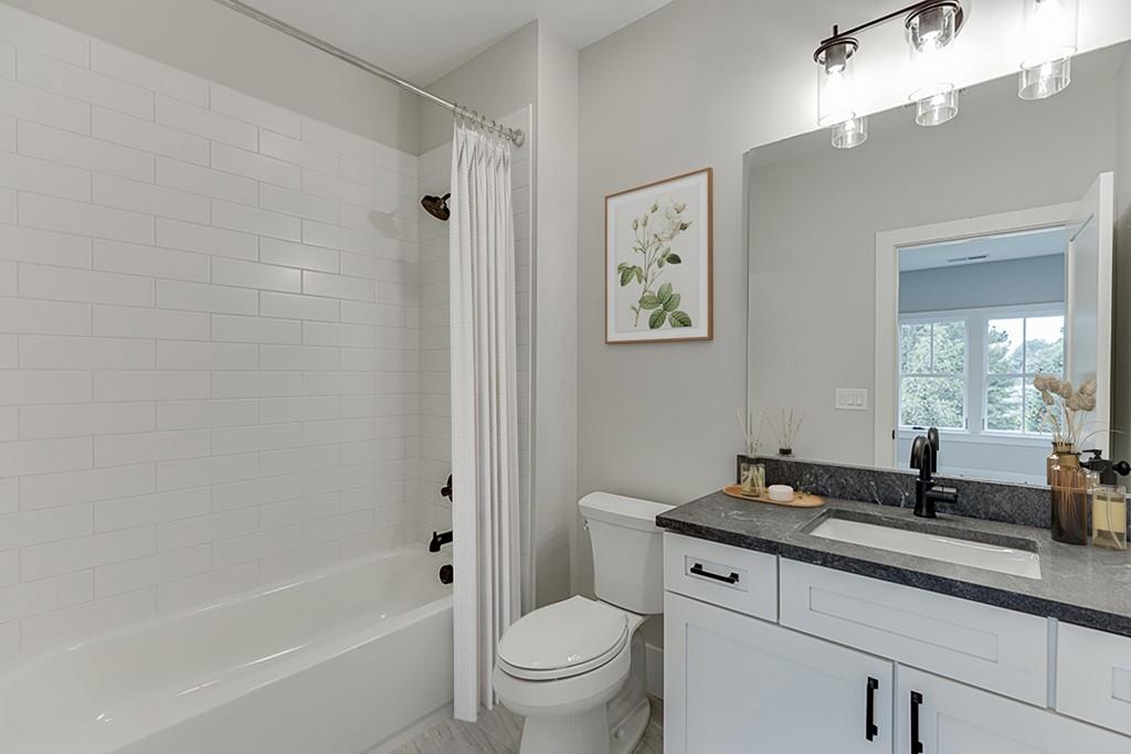 7620 Breeze Bay Road Cumming, GA 30041 - Photo 39 of 53 a bath room with a toilet a sink and a bath tub