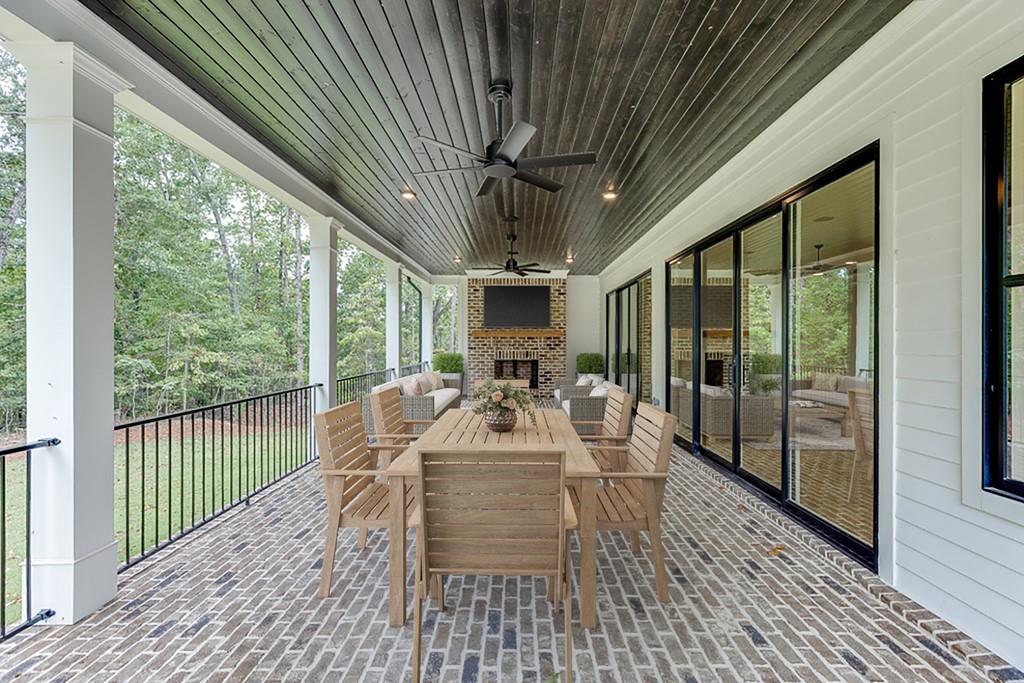 7620 Breeze Bay Road Cumming, GA 30041 - Photo 44 of 53 a dining room with furniture wooden floor and chandelier