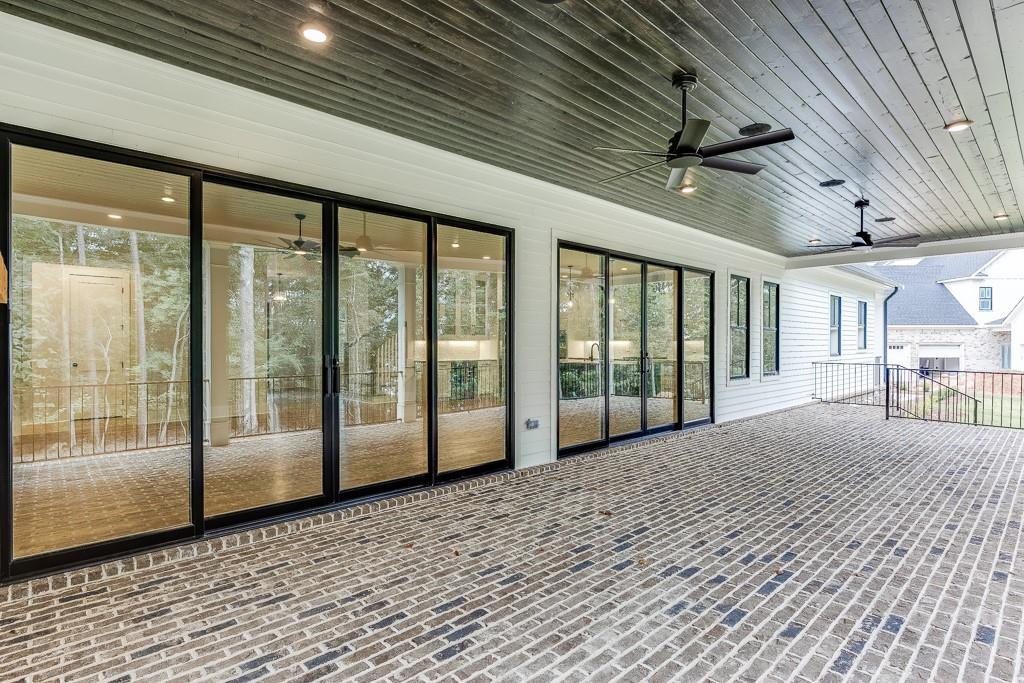 7620 Breeze Bay Road Cumming, GA 30041 - Photo 45 of 53 a view of a porch with a table and chairs