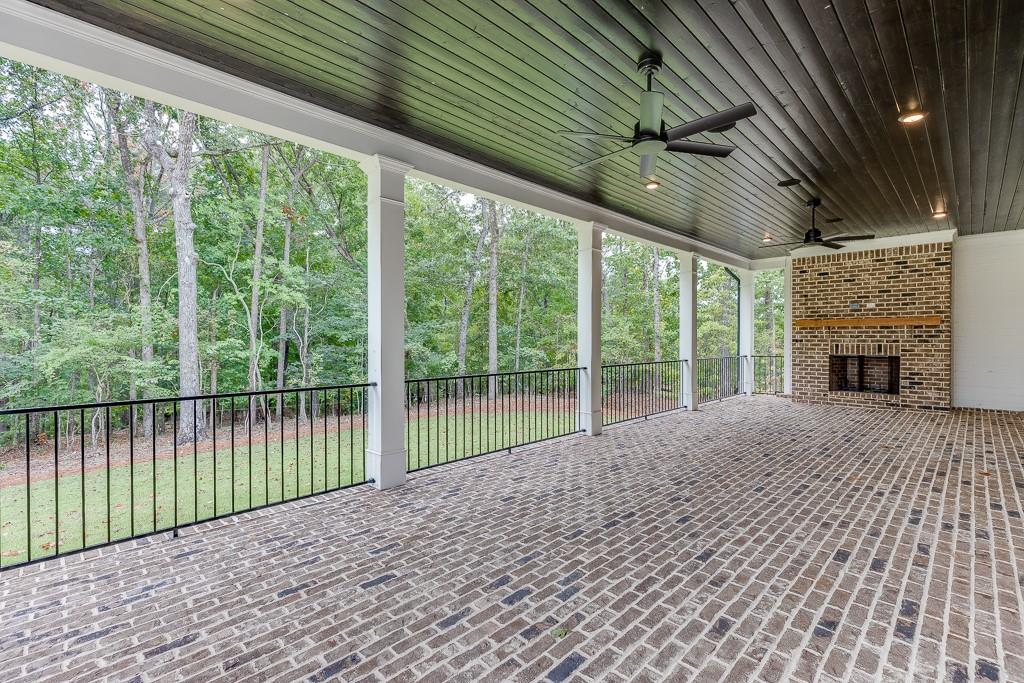 7620 Breeze Bay Road Cumming, GA 30041 - Photo 46 of 53 a porch with a table and chairs