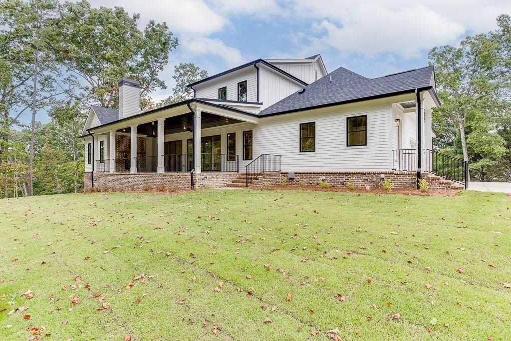 7620 Breeze Bay Road Cumming, GA 30041 - Photo 47 of 53 a front view of a house with a yard