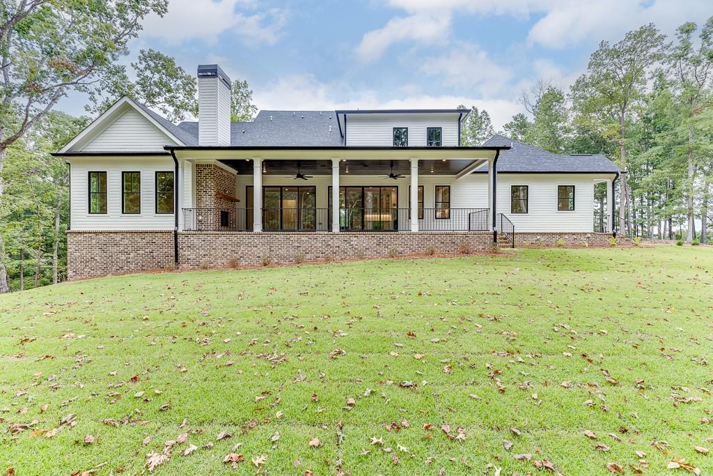 7620 Breeze Bay Road Cumming, GA 30041 - Photo 48 of 53 a view of a yard in front of a house with large windows