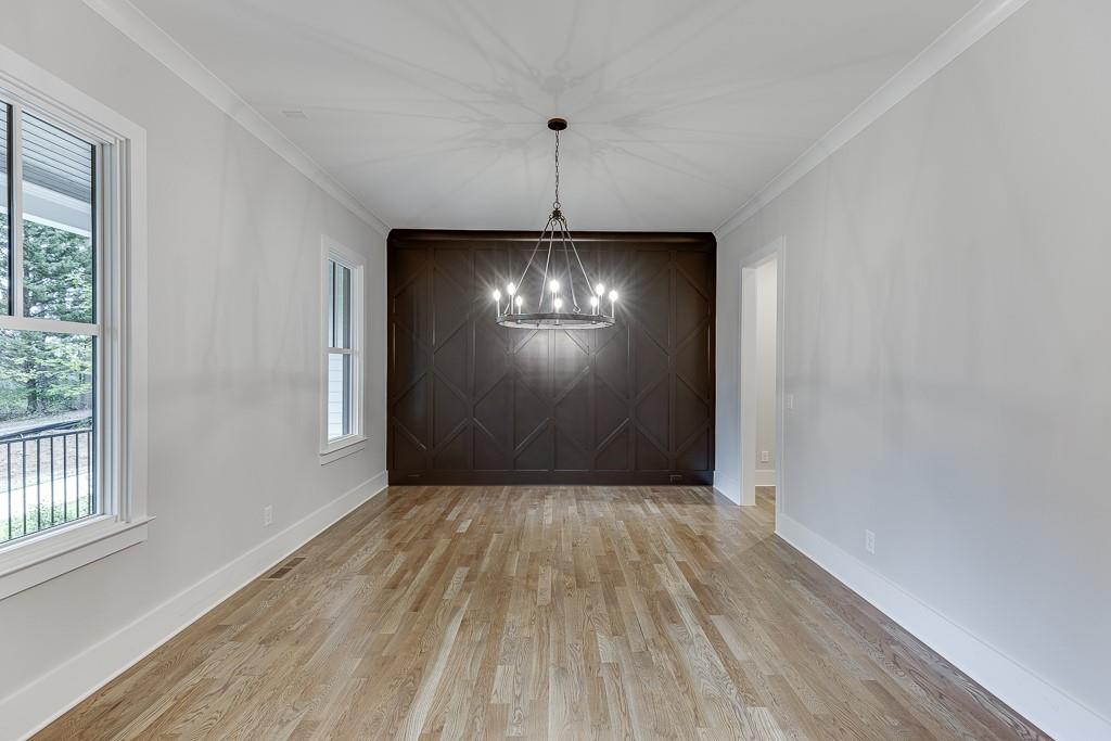 7620 Breeze Bay Road Cumming, GA 30041 - Photo 5 of 53 a view of a room with wooden floor and windows