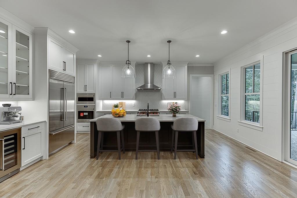 7620 Breeze Bay Road Cumming, GA 30041 - Photo 8 of 53 a large kitchen with a table and chairs