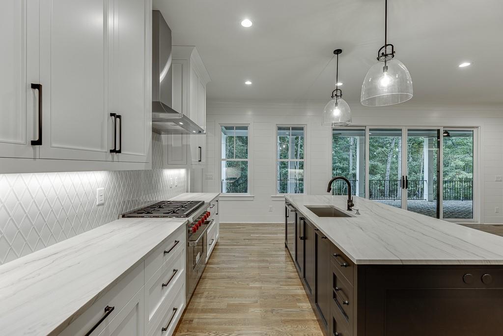 7620 Breeze Bay Road Cumming, GA 30041 - Photo 10 of 53 a kitchen with stainless steel appliances granite countertop a sink and a stove