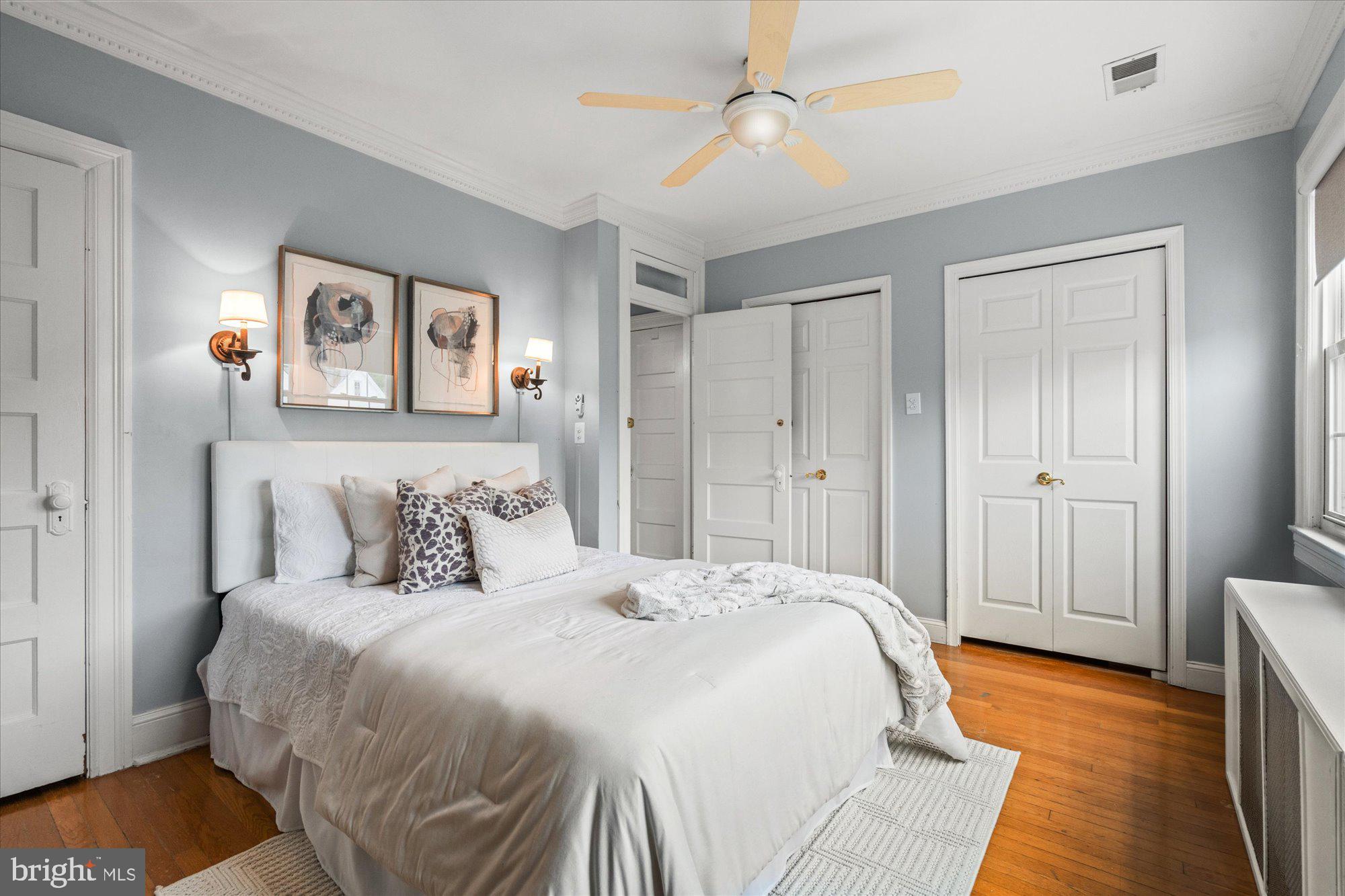 2305 38th Street Northwest Washington, DC 20007 - Photo 20 of 38 a bedroom with a large bed and a chandelier