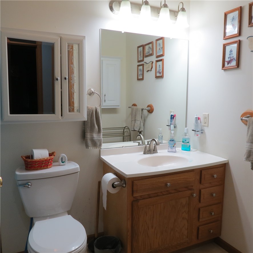 21242 Dingman-Slagle Road Pemberton, OH 45353 - Photo 16 of 33 This bathroom features a functional vanity with ample storage and a sleek, well-lit mirror.