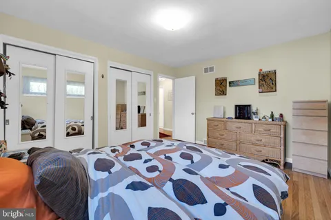 a bedroom with a bed and lamp