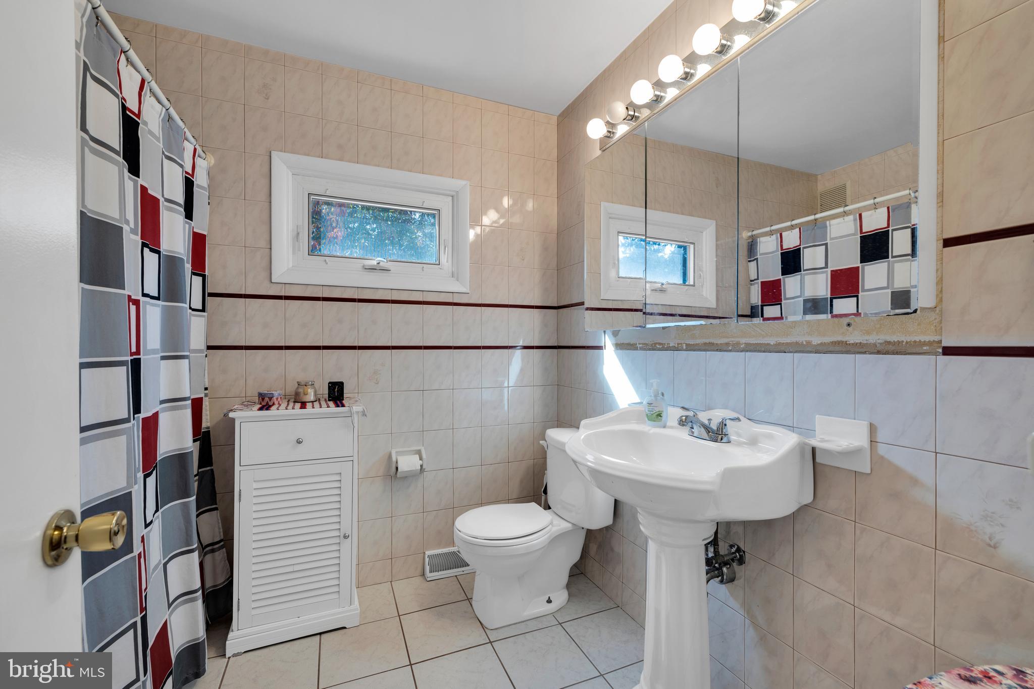 411 North Tulpehocken Road Reading, PA 19601 - Photo 20 of 27 a bathroom with a sink mirror and toilet