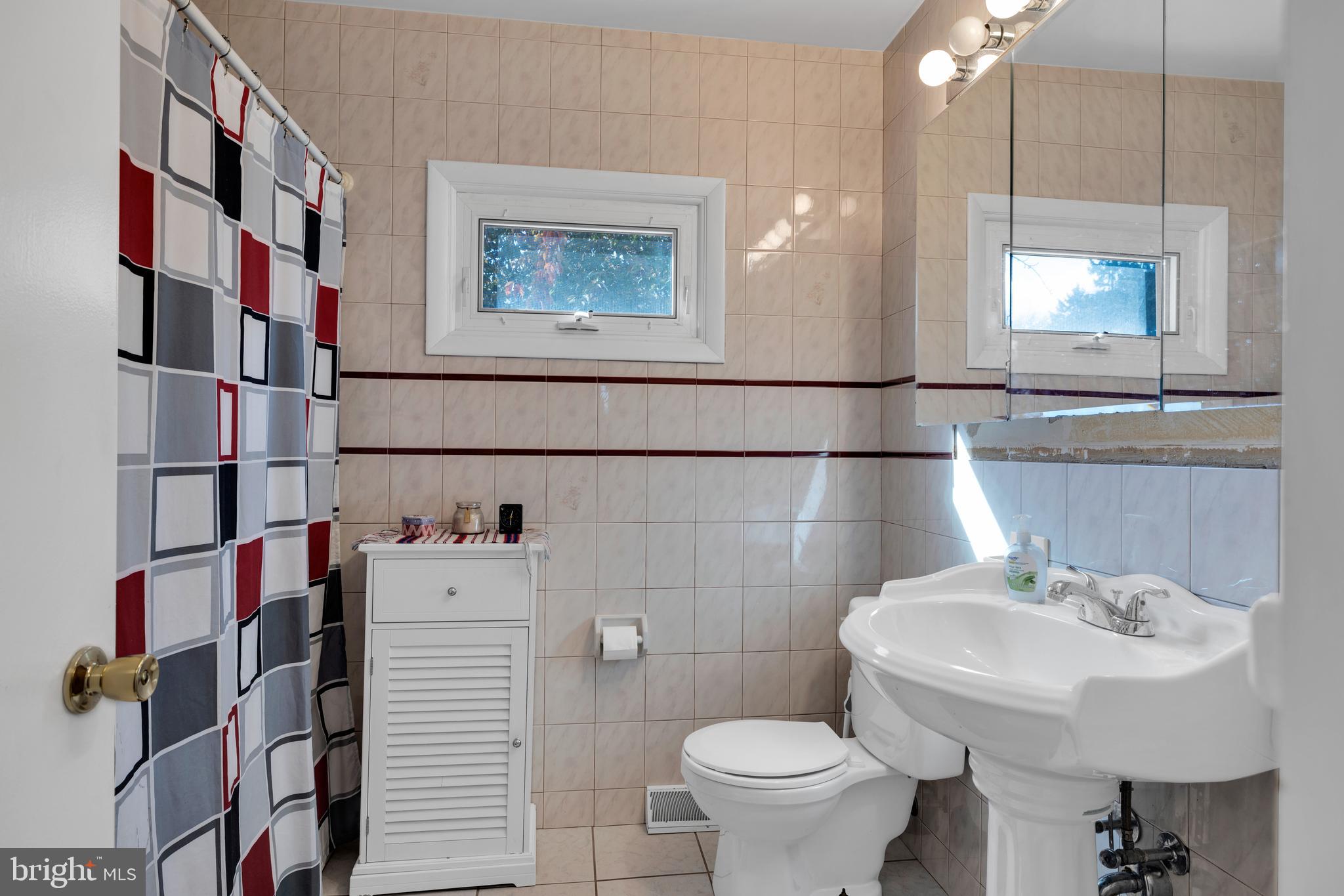 411 North Tulpehocken Road Reading, PA 19601 - Photo 21 of 27 a bathroom with a sink toilet and a mirror
