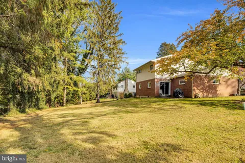 a yellow house with trees in front of it