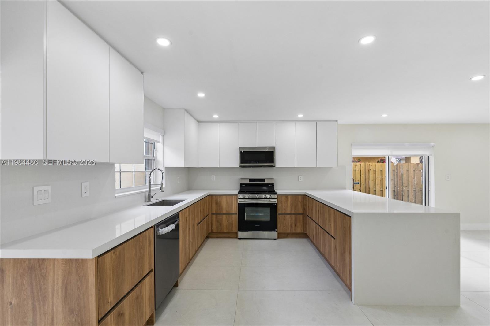 15174 Southwest 111th Street Miami, FL 33196 - Photo 11 of 49 a kitchen with stainless steel appliances granite countertop a sink and cabinets