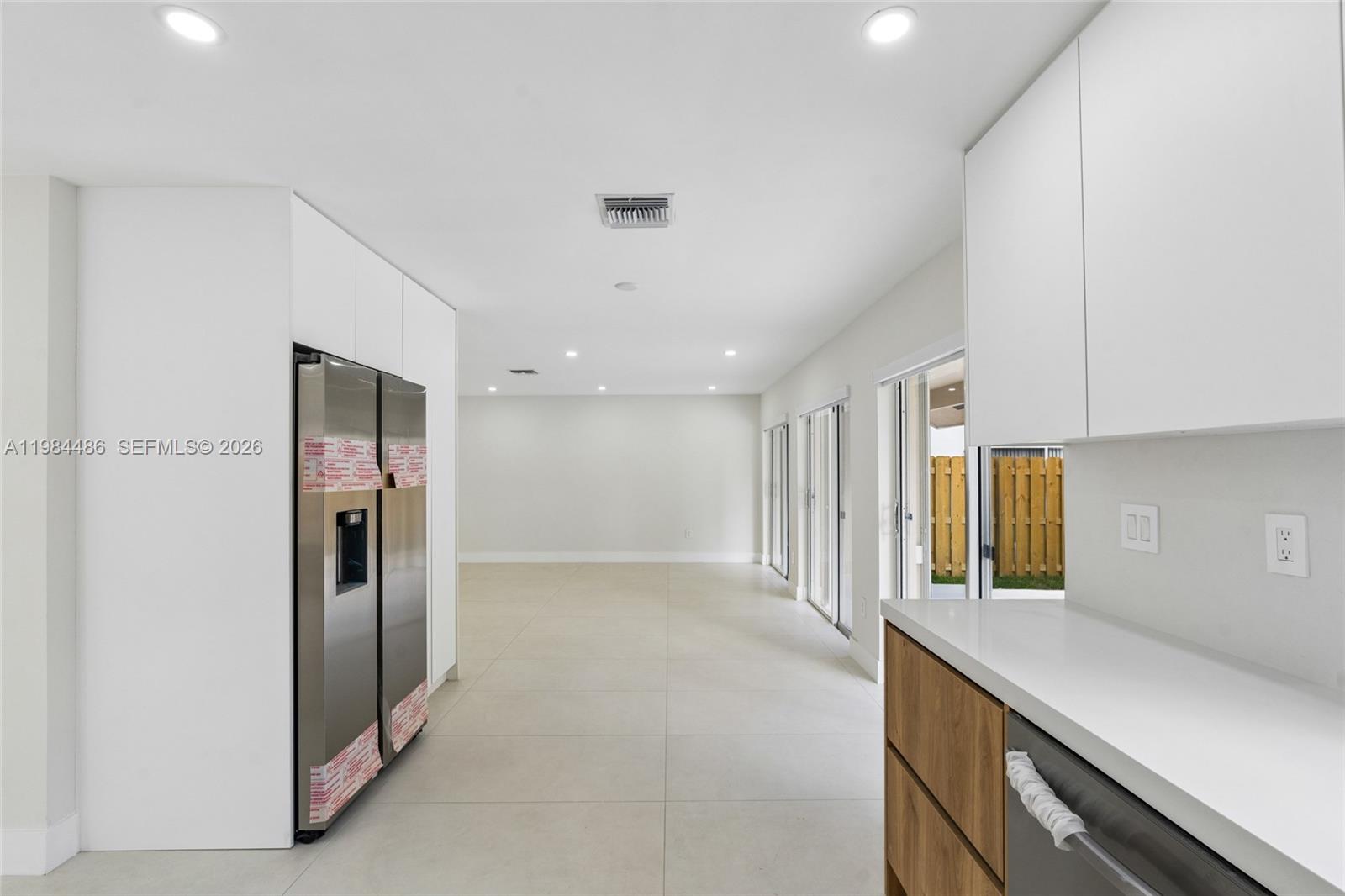 15174 Southwest 111th Street Miami, FL 33196 - Photo 12 of 49 a view of a kitchen with a refrigerator and a sink