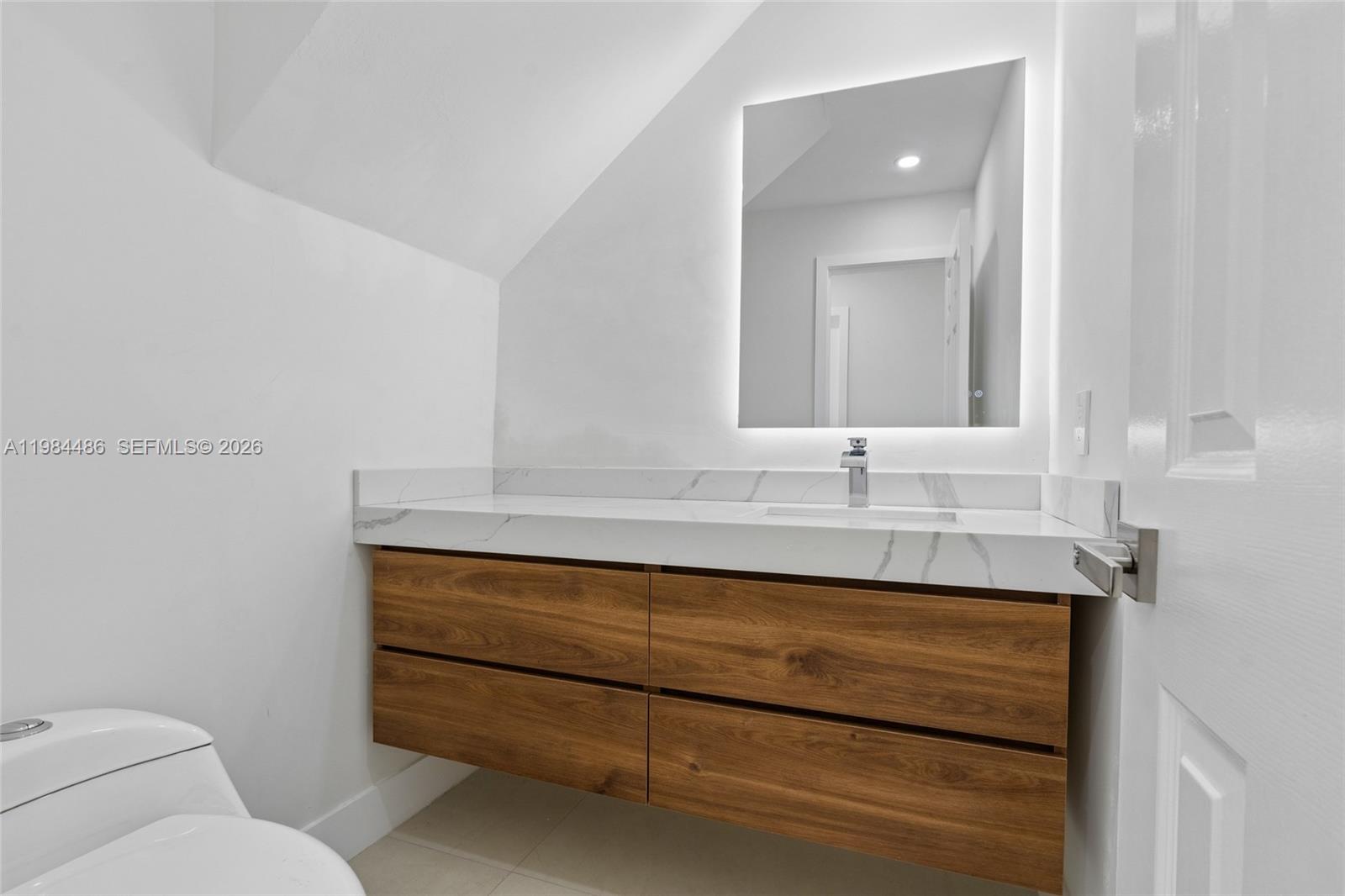 15174 Southwest 111th Street Miami, FL 33196 - Photo 16 of 49 a bathroom with a sink and a mirror