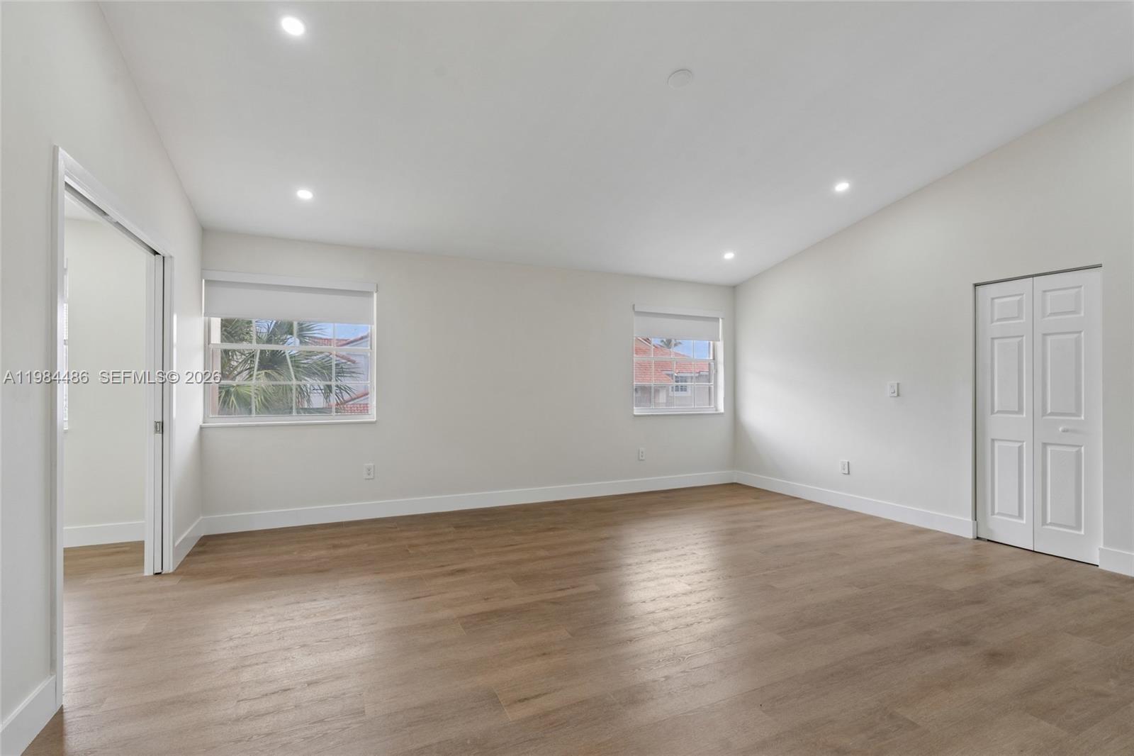 15174 Southwest 111th Street Miami, FL 33196 - Photo 19 of 49 an empty room with wooden floor and windows