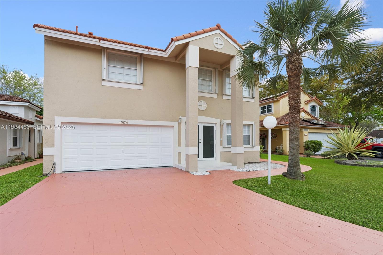 15174 Southwest 111th Street Miami, FL 33196 - Photo 2 of 49 a front view of a house with a yard and garage