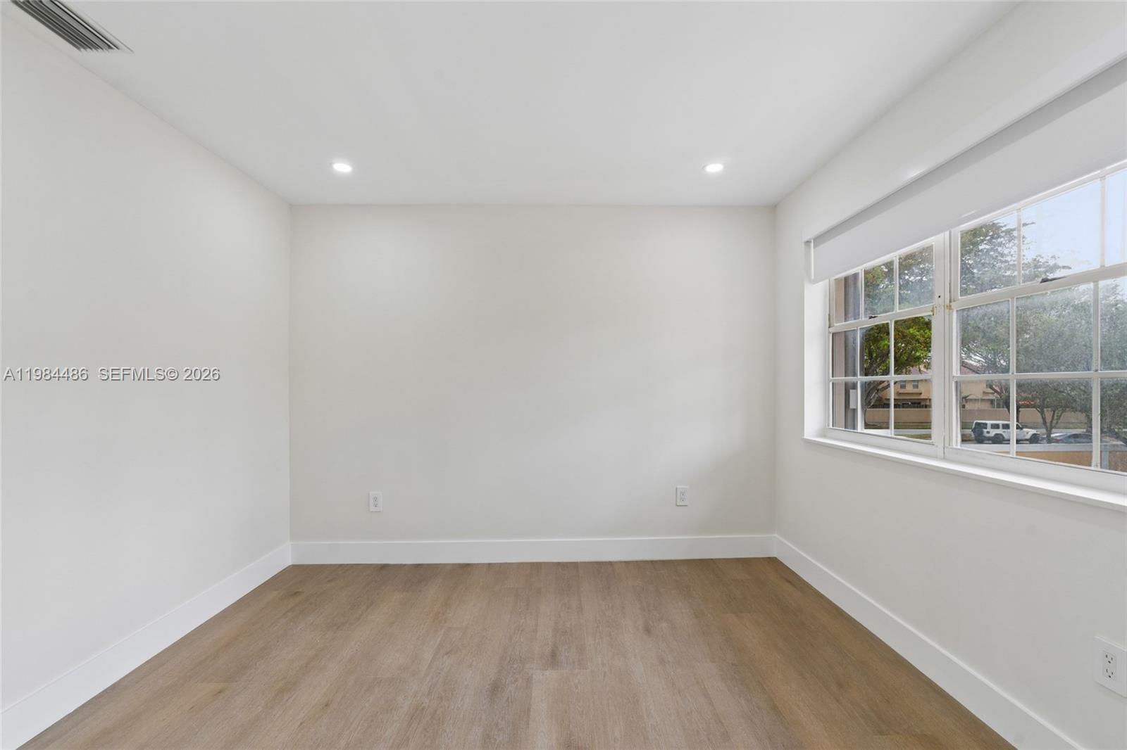 15174 Southwest 111th Street Miami, FL 33196 - Photo 21 of 49 an empty room with a window