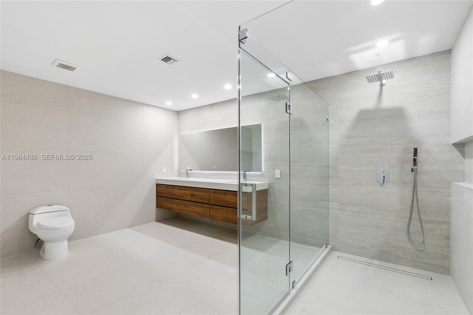 15174 Southwest 111th Street Miami, FL 33196 - Photo 22 of 49 a bathroom with a shower and a toilet sink