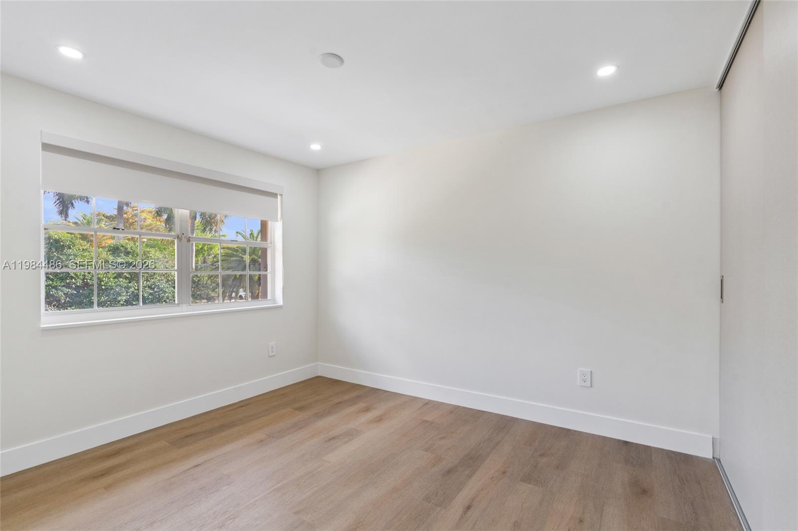 15174 Southwest 111th Street Miami, FL 33196 - Photo 28 of 49 an empty room with wooden floor and windows