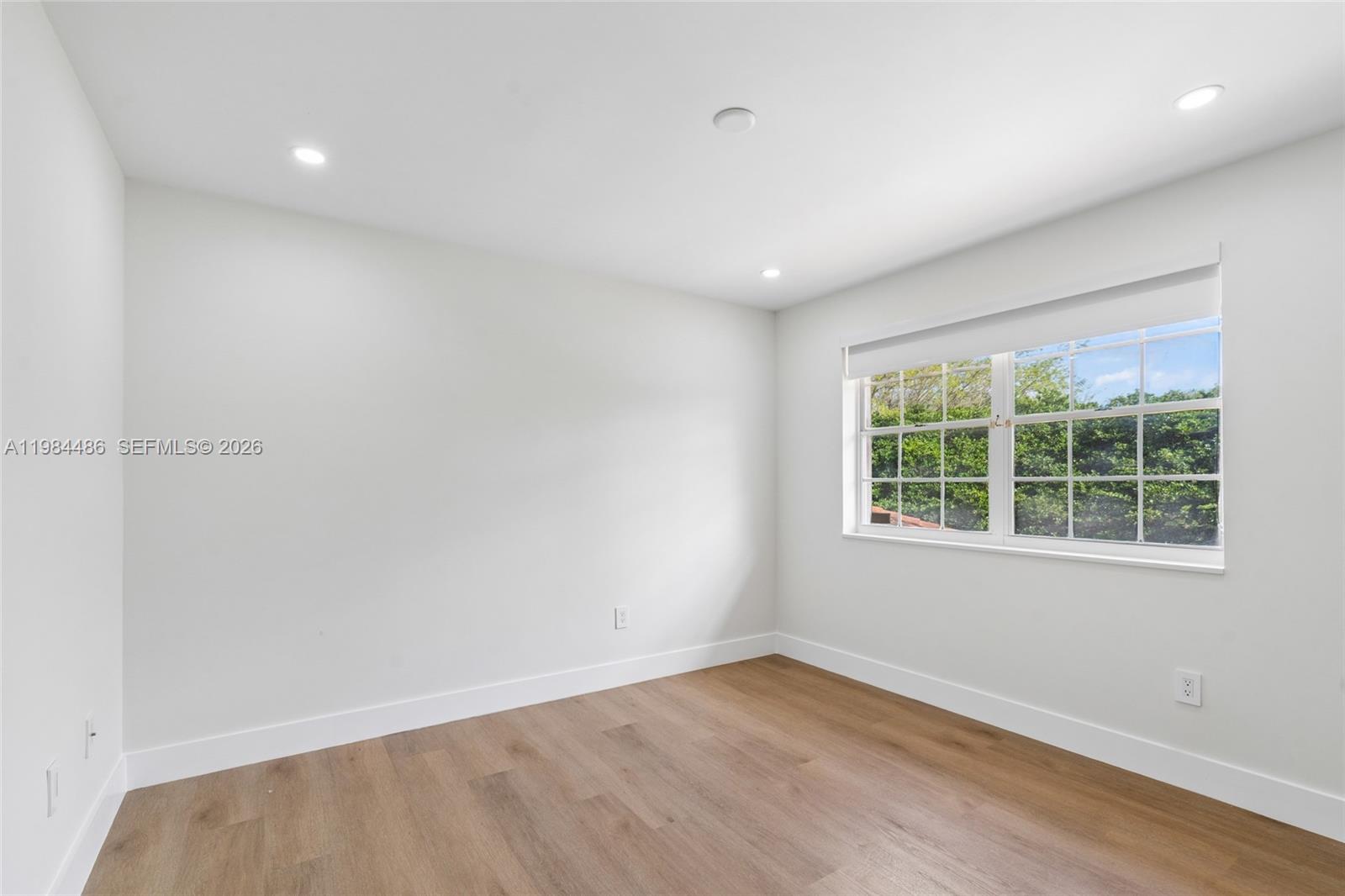 15174 Southwest 111th Street Miami, FL 33196 - Photo 30 of 49 an empty room with wooden floor and windows