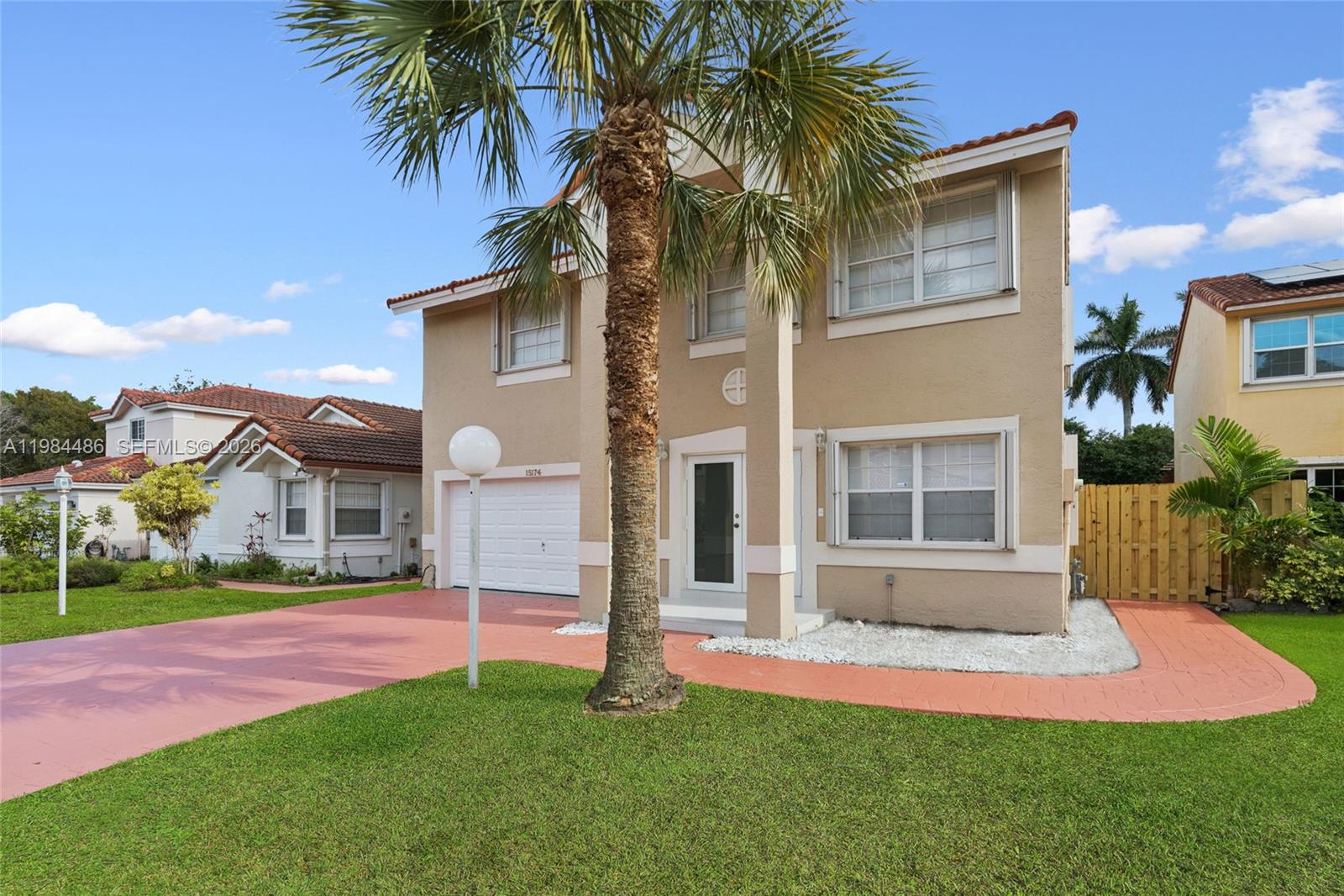 15174 Southwest 111th Street Miami, FL 33196 - Photo 3 of 49 a front view of a house with a garden and yard