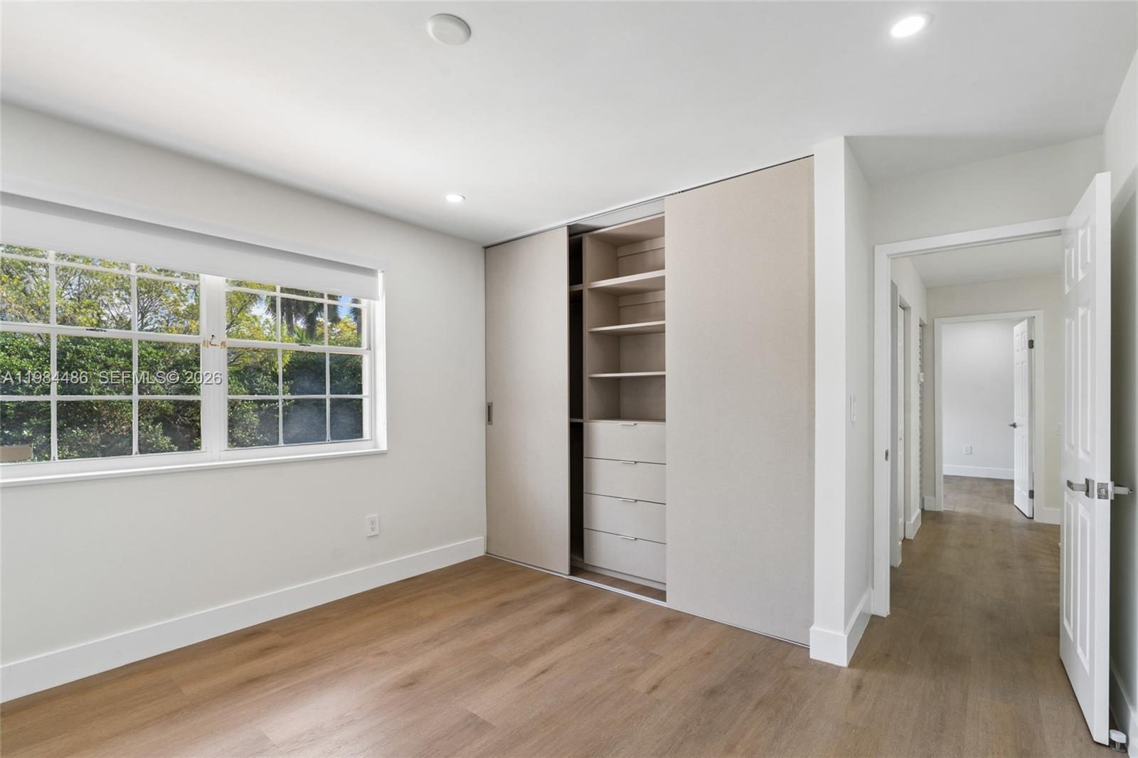 15174 Southwest 111th Street Miami, FL 33196 - Photo 31 of 49 an empty room with wooden floor and windows