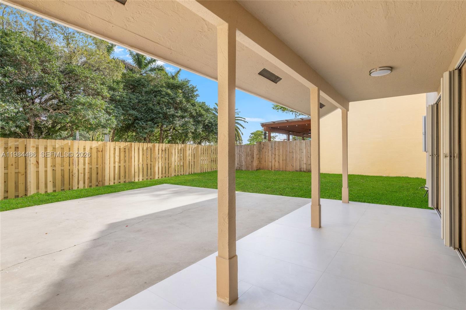 15174 Southwest 111th Street Miami, FL 33196 - Photo 36 of 49 a view of a road with fence