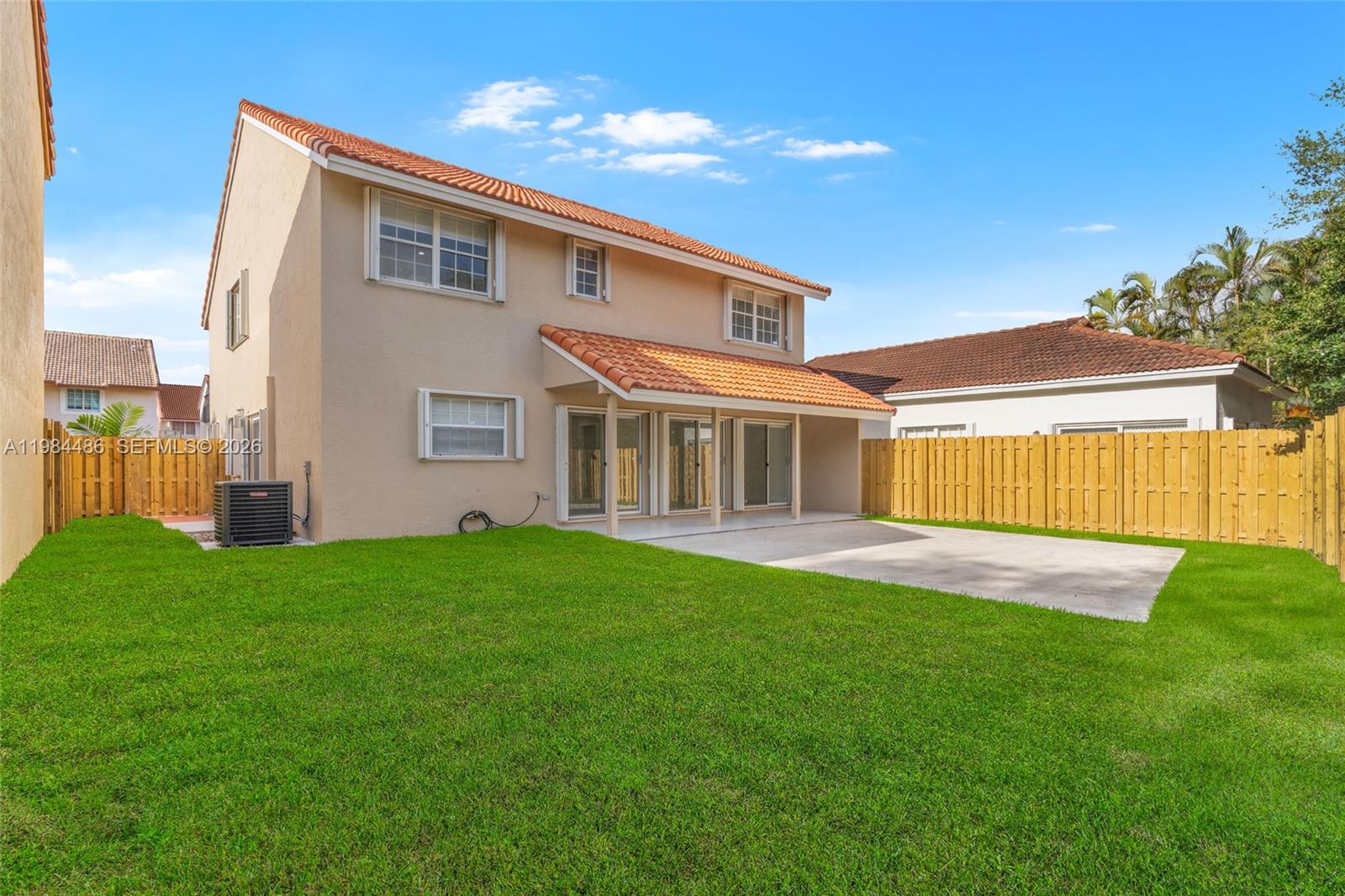 15174 Southwest 111th Street Miami, FL 33196 - Photo 39 of 49 a front view of a house with a garden and yard