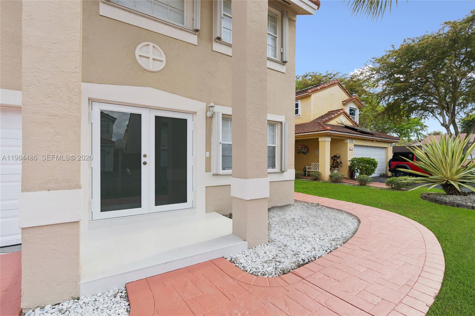 15174 Southwest 111th Street Miami, FL 33196 - Photo 4 of 49 a front view of a house with a yard
