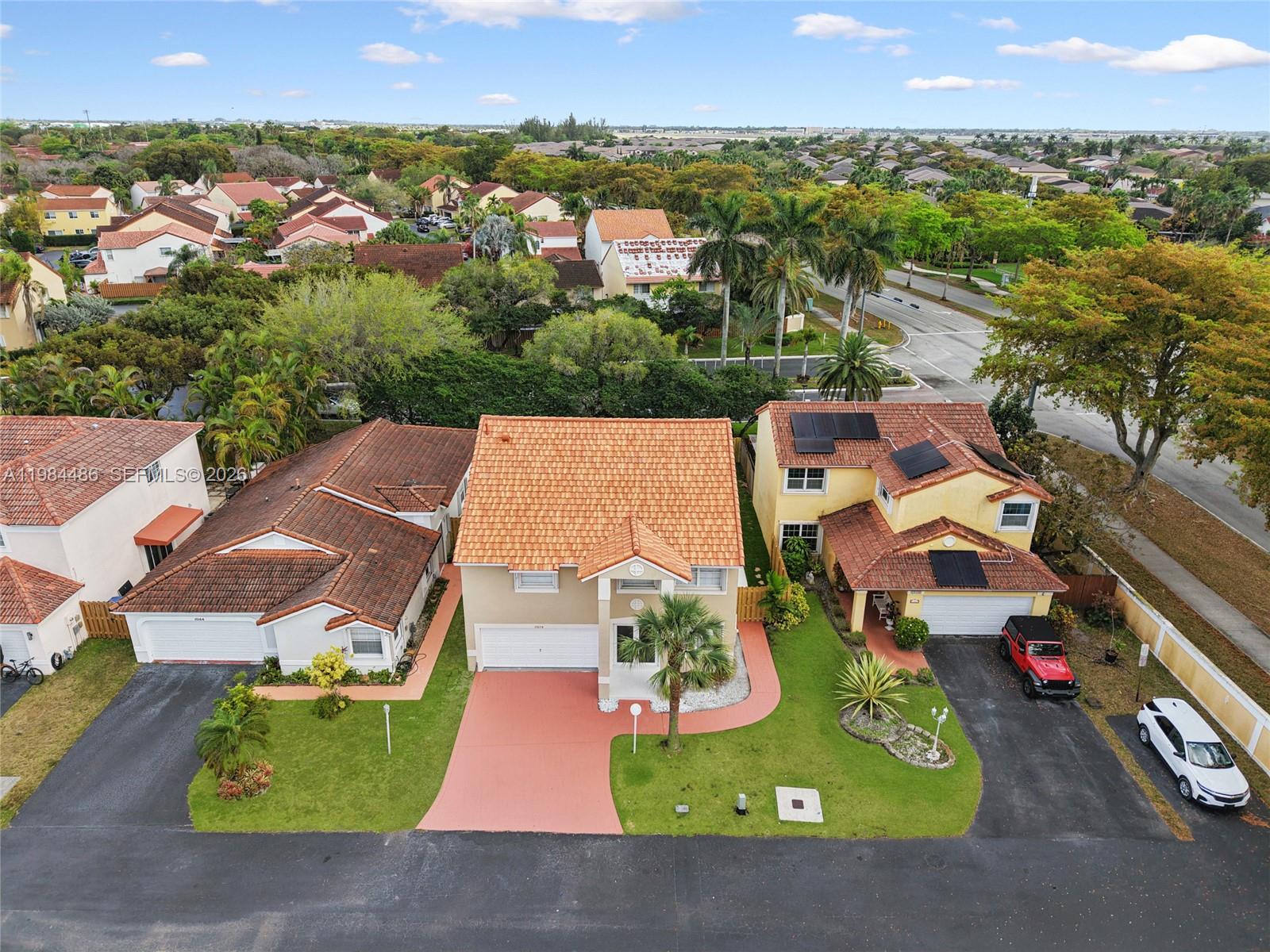 15174 Southwest 111th Street Miami, FL 33196 - Photo 43 of 49 an aerial view of residential houses with outdoor space and parking