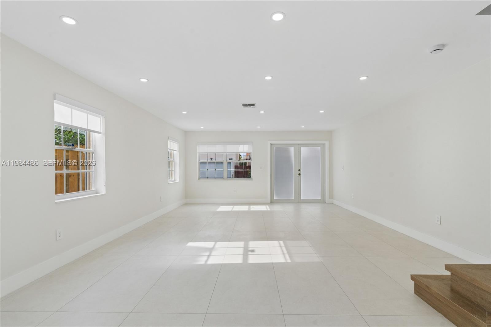 15174 Southwest 111th Street Miami, FL 33196 - Photo 7 of 49 a view of an empty room with a window