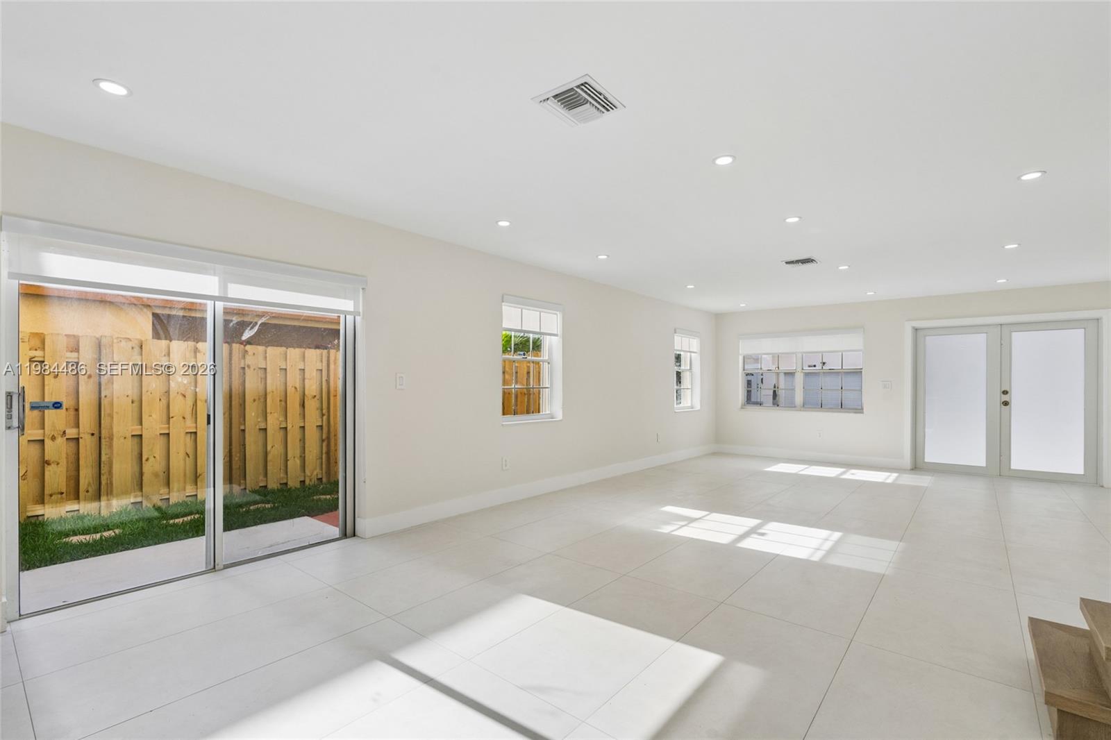 15174 Southwest 111th Street Miami, FL 33196 - Photo 8 of 49 a view of an empty room with glass door