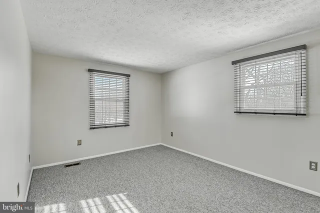 a view of room with window and ceiling fan