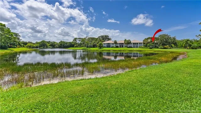 a living room with furniture a rug and a large window