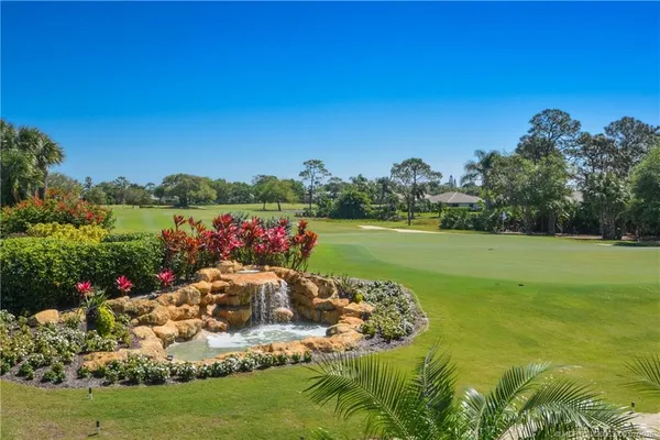 a view of a garden with an ocean view