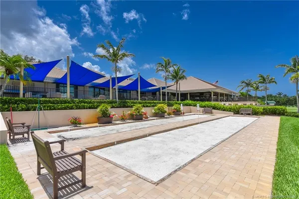 a view of patio with table and chairs under an umbrella