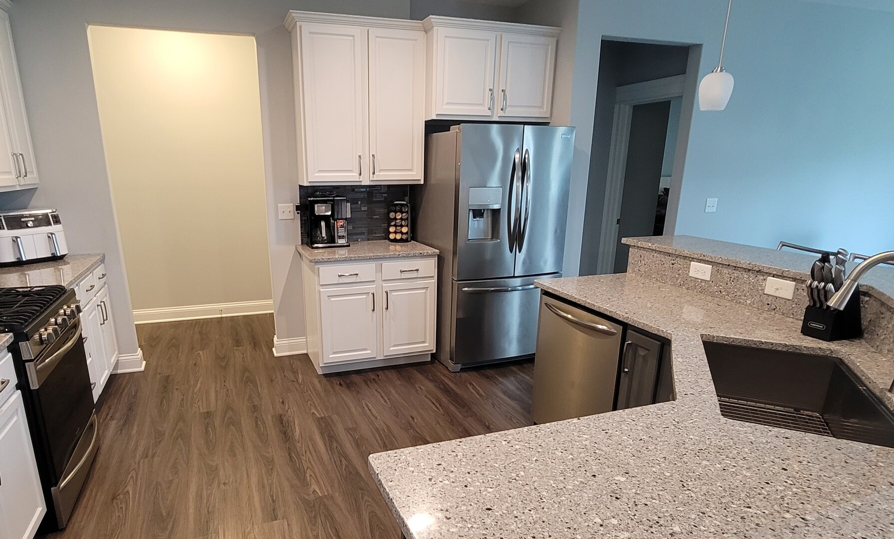 1919 Truman Street Sycamore, IL 60178 - Photo 16 of 50 a kitchen with stainless steel appliances a refrigerator stove and wooden floor