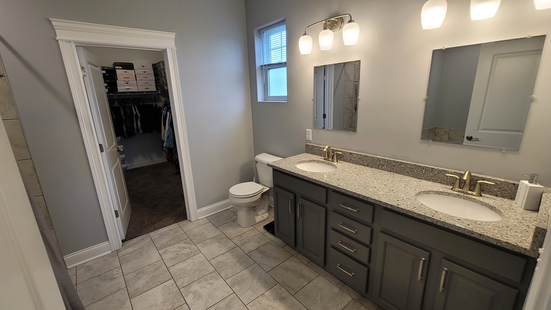 1919 Truman Street Sycamore, IL 60178 - Photo 19 of 50 a spacious bathroom with a granite countertop sink and a mirror