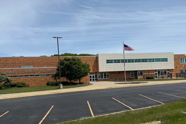 a view of a swimming pool with a yard and table or chairs