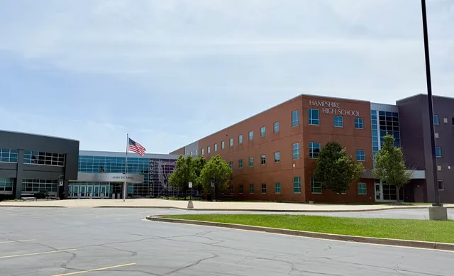a view of a tall building next to a yard