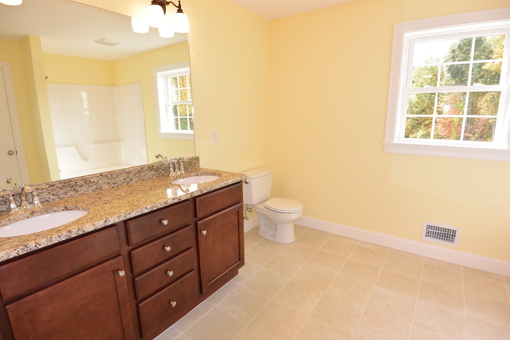 33 Runaway Brook Road Lancaster, MA 01523 - Photo 11 of 15 a bathroom with a granite countertop sink a toilet and a tub