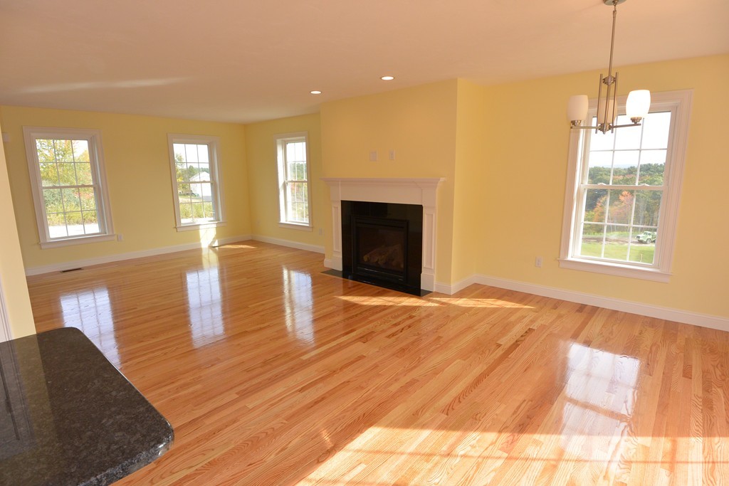 33 Runaway Brook Road Lancaster, MA 01523 - Photo 6 of 15 a view of empty room with wooden floor and fireplace