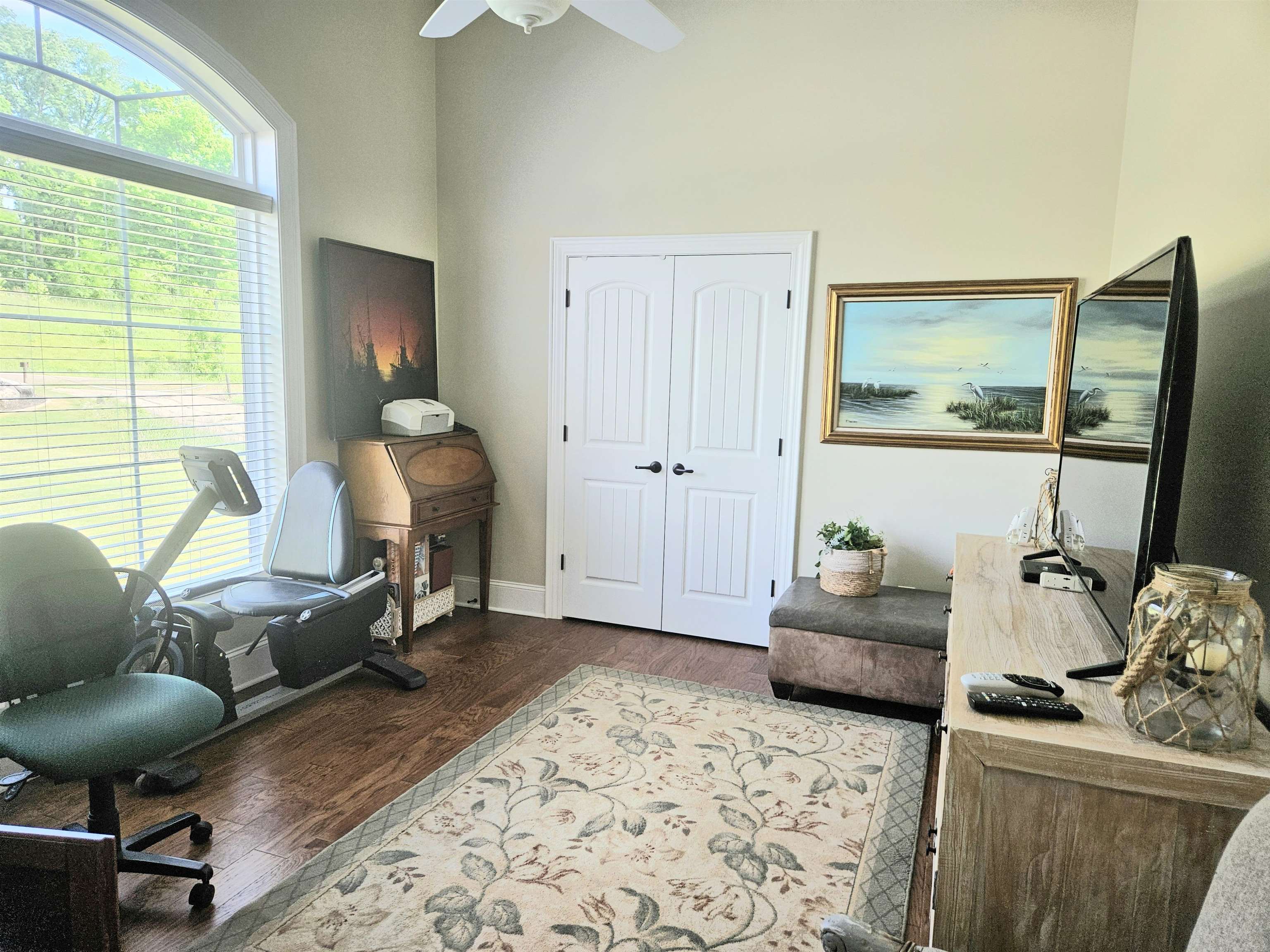 7095 Clifton Road Savannah, TN 38372 - Photo 6 of 25 Home office with dark wood-type flooring, a high ceiling, ceiling fan, and baseboards
