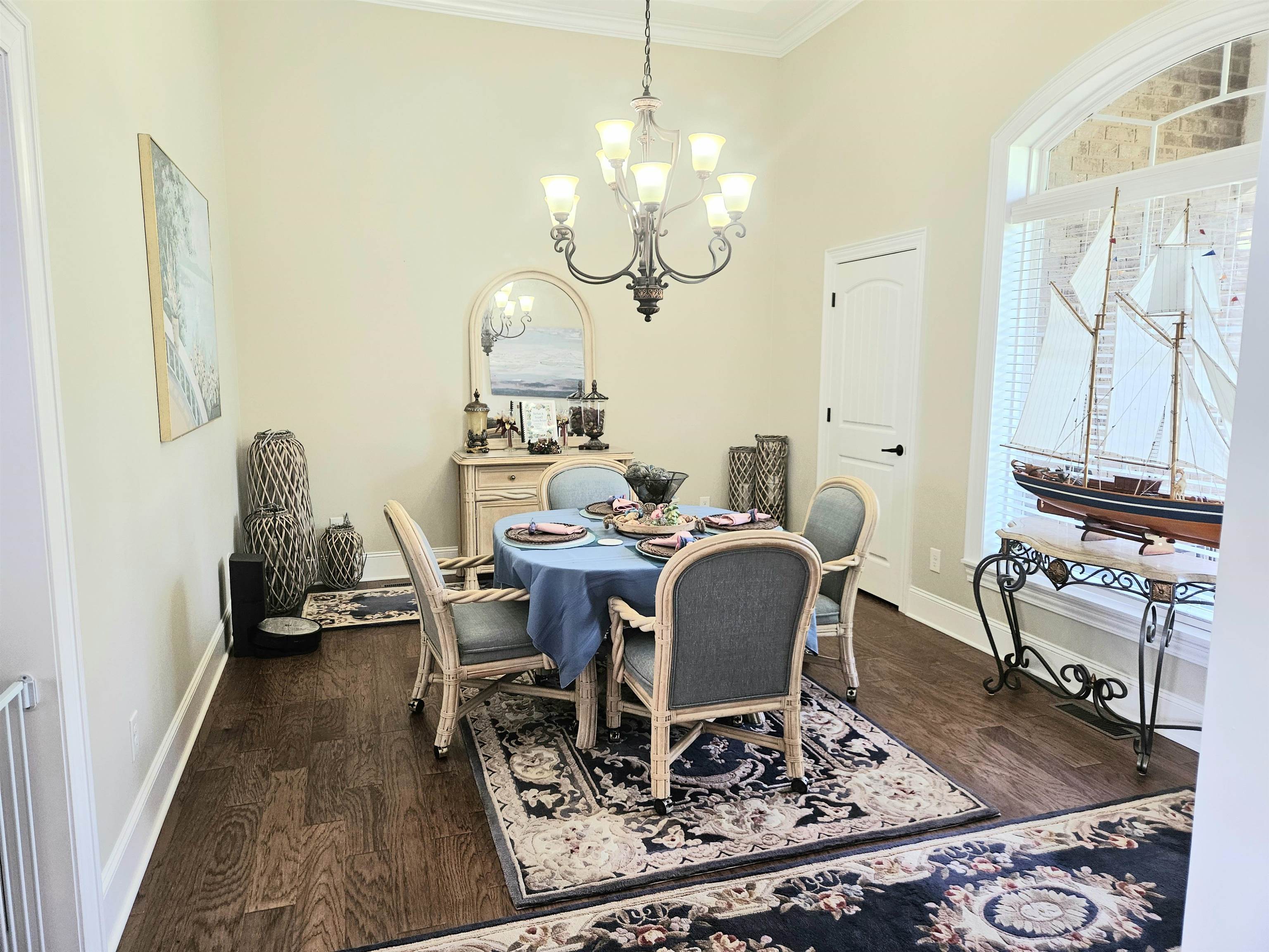 7095 Clifton Road Savannah, TN 38372 - Photo 7 of 25 Dining area with crown molding, baseboards, a chandelier, and dark wood finished floors