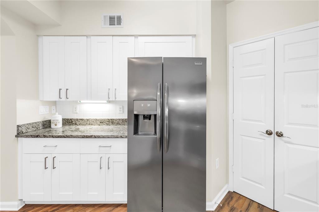 4206 Bay Club Circle, Unit 4206 Tampa, FL 33607 - Photo 11 of 60 a kitchen with a refrigerator and cabinets